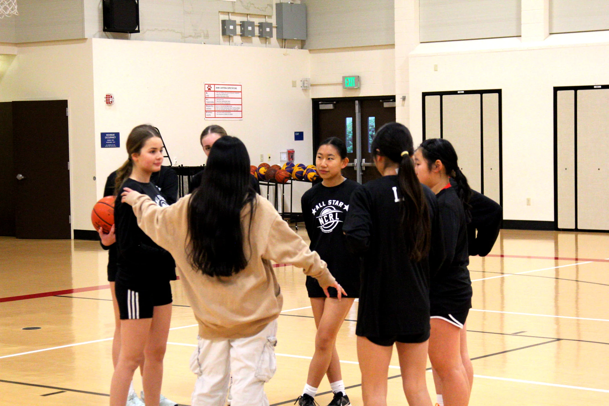 Athletes and coach on the court